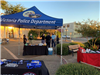 Police and residents mingle near a Victoria Police Department booth in the City Hall courtyard.
