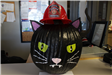 A pumpkin painted like a black cat's head wearing a firefighter helmet: Official Junior Firefight