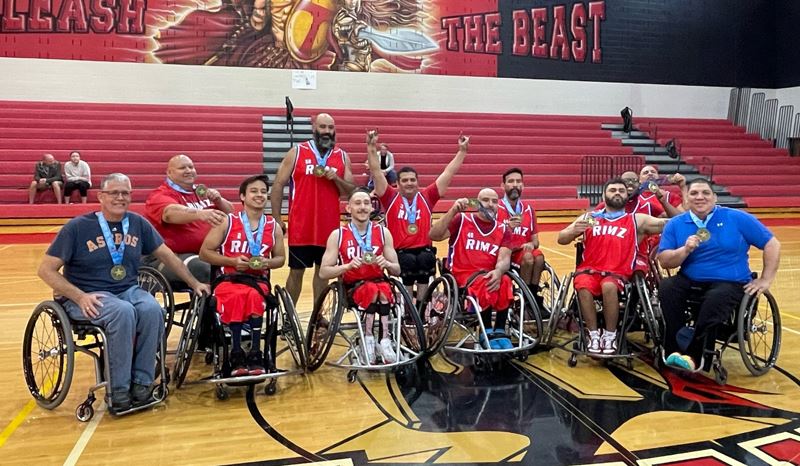 Team of wheelchair basketball players display their medals