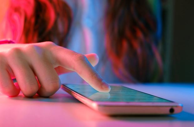 Closeup of a hand selecting something on a phone touchscreen