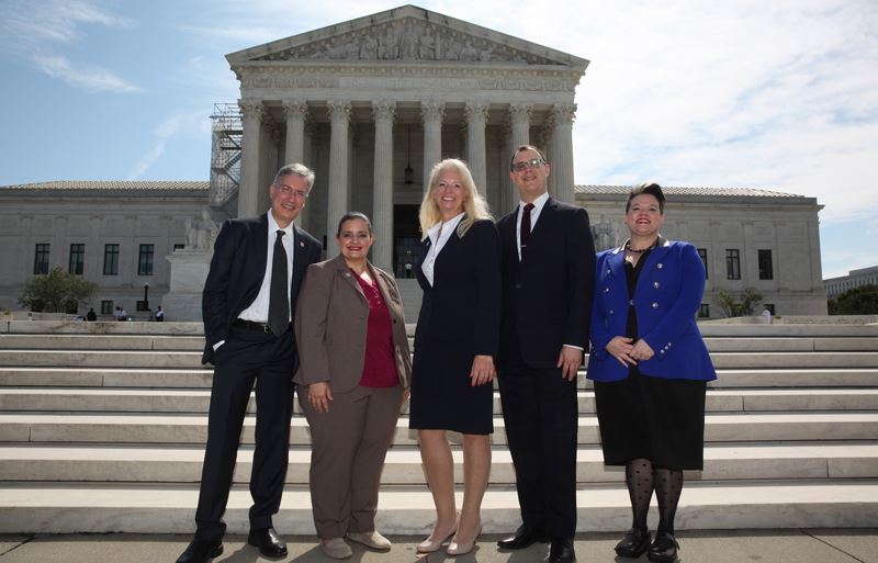 Group photo of 5 people in front of the Supreme Court building