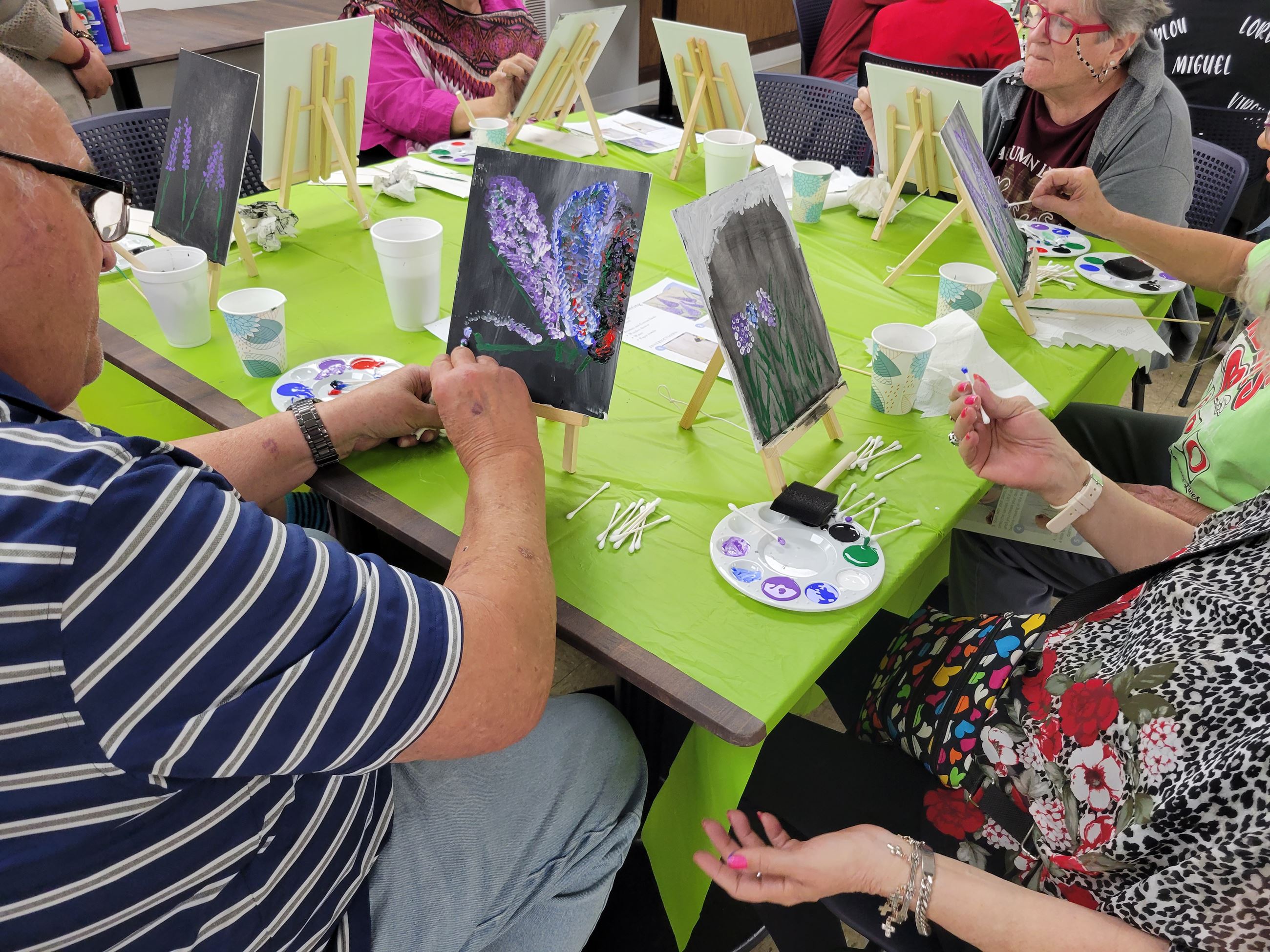 People painting flowers during the MOW program