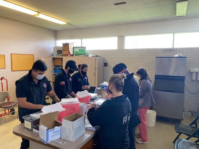 Members of the Victoria Fire Department and Megan Garcia prepare the COVID-19 for Meals on Wheels