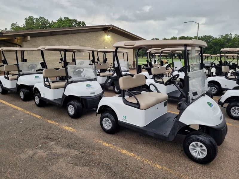 Many golf carts parked near Riverside Golf Course clubhouse