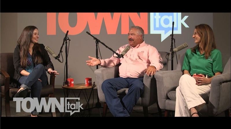 Three people in chairs with studio mics. TOWNtalk logo is displayed