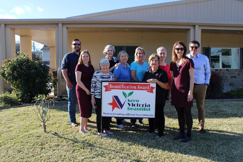 Group photo with KVB sign in front of Twice Blessed Showroom