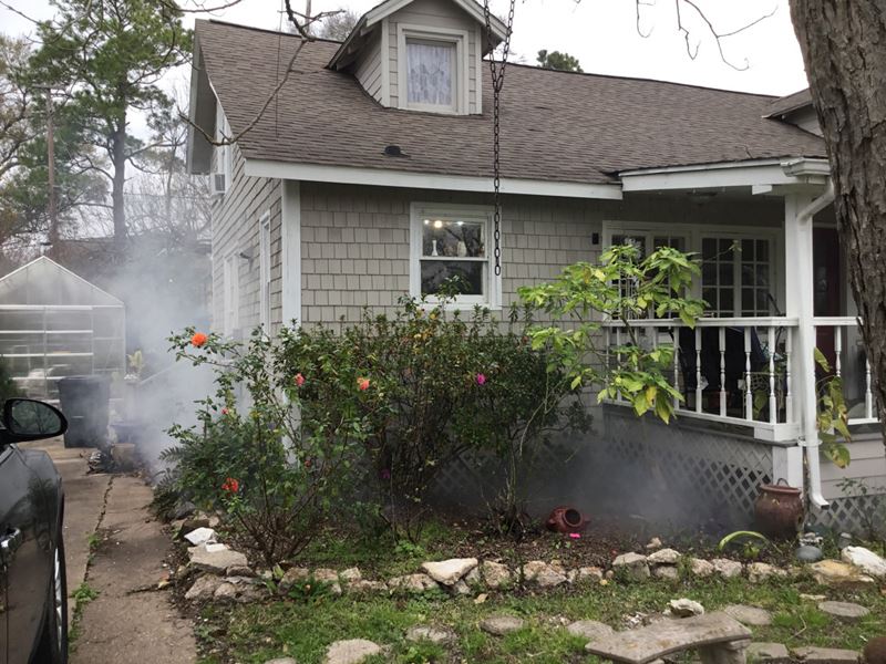 White smoke rises from the base of a home