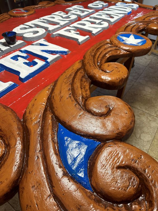 A detailed shot of the Street of Ten Friends sign showing the finish on the border