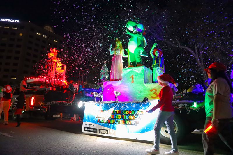 Lighted parade float featuring costumed Super Mario characters and surrounded by fake snow Opens in new window