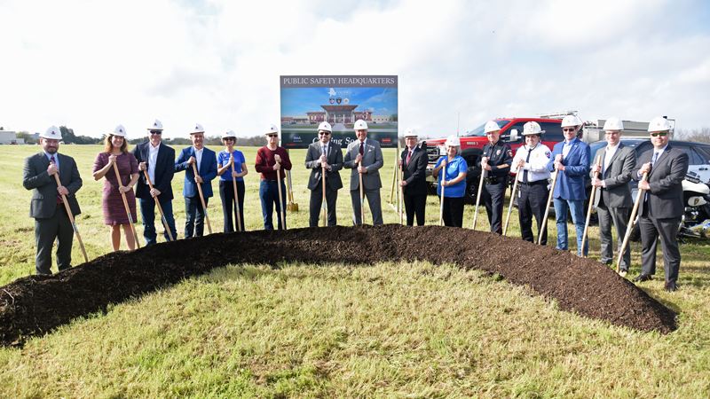 Group photo of people with ceremonial shovels and hard hats