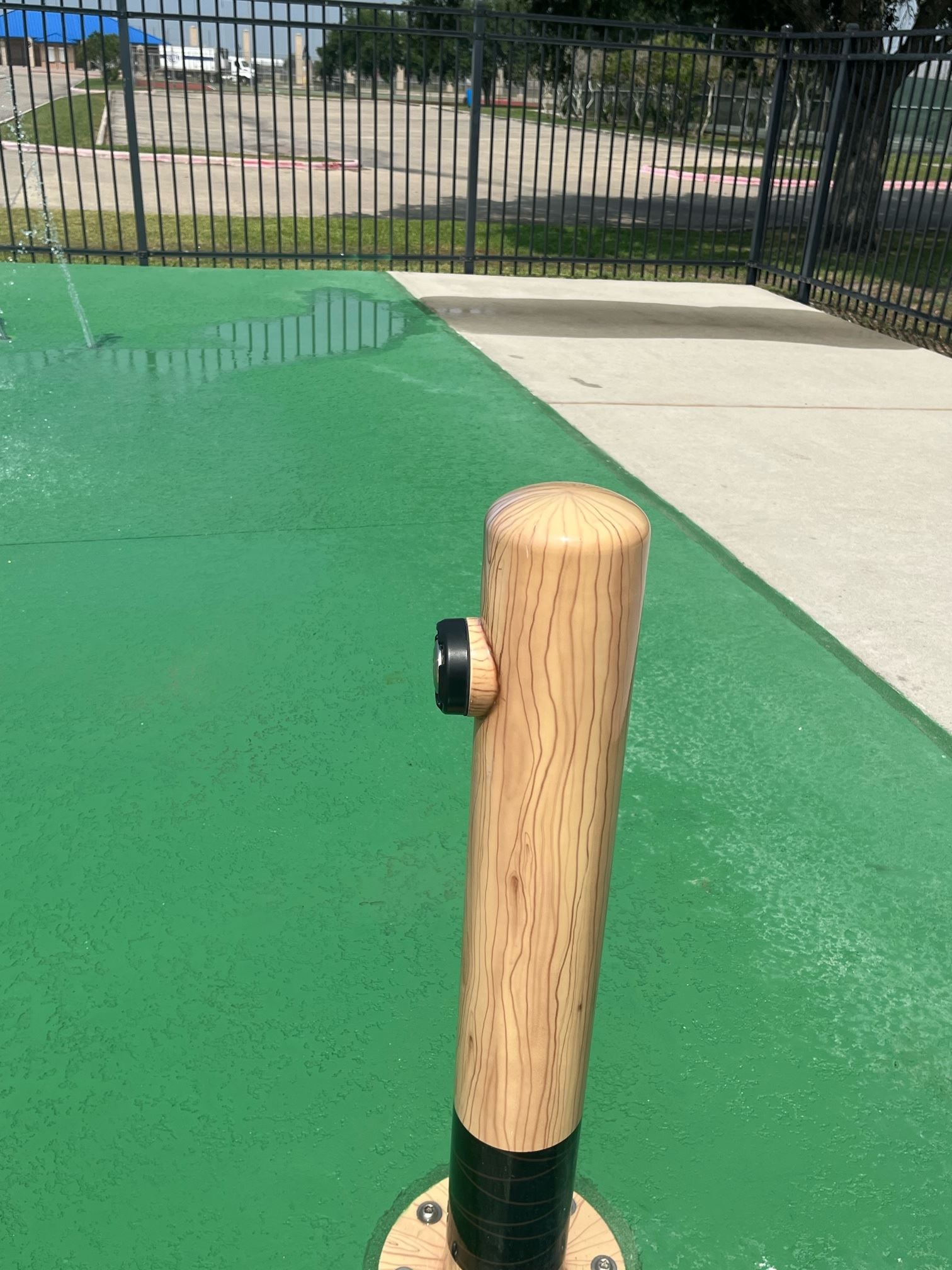 An oversized baseball bat that activates the splash pad. 