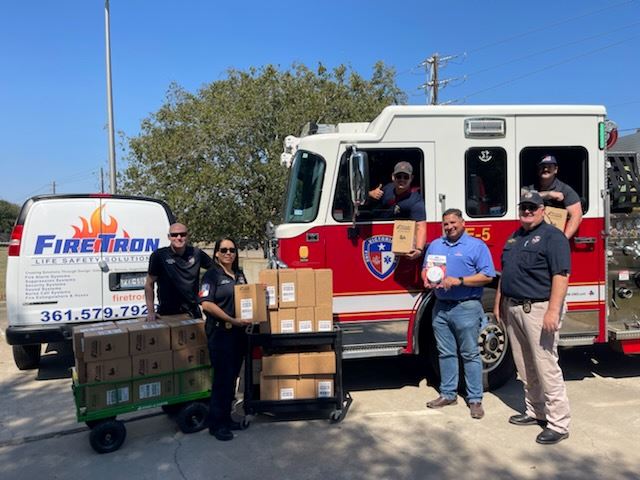 FireTron of Victoria donating smoke alarms to the fire department.