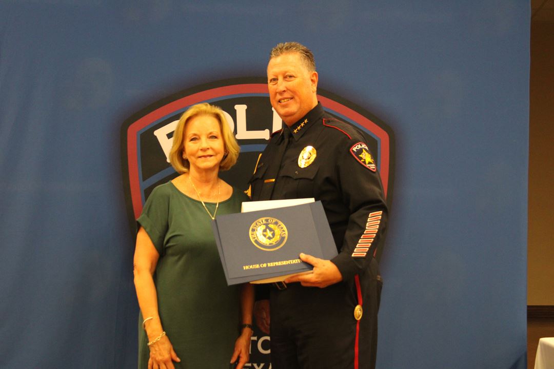 State Representative Geanie Morrison presents Victoria Police Department Chief J.J. Craig with an Am