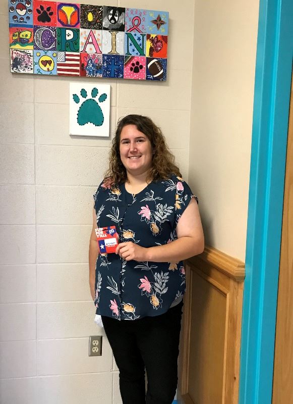 Woman holds Academy Sports and Outdoors gift card