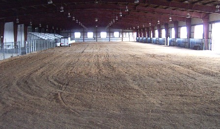 Arena with dirt floor and bleacher seating