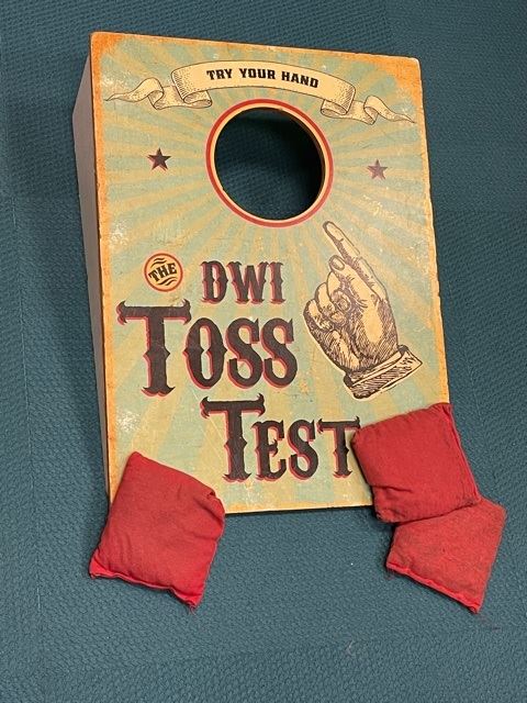 A bean bag toss game. The board is labeled 